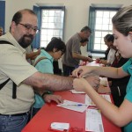 Após o check-in, agentes receberam um cartão de embarque simbólico e uma pulseira com o número dos quartos