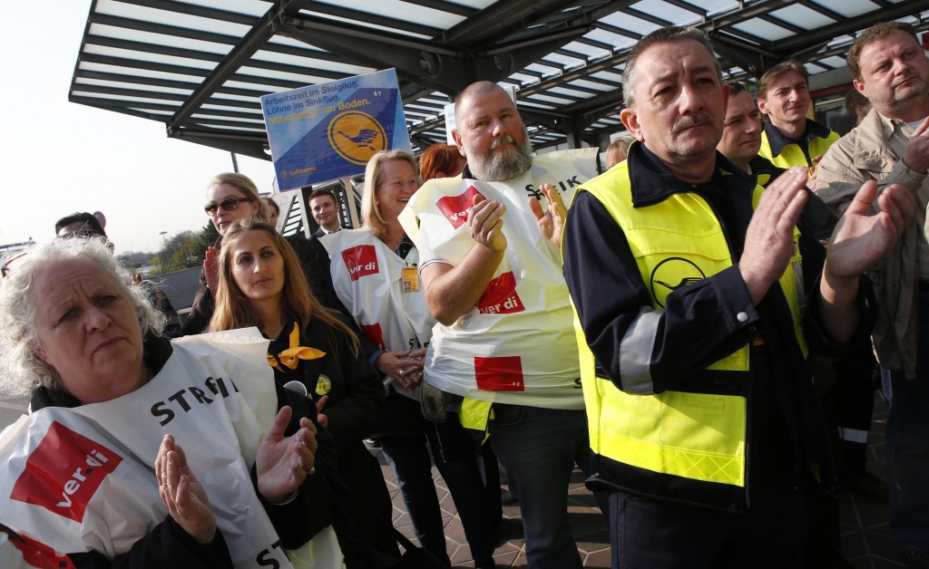 Union members attend a rally as they take part in a warning strike of German air carrier Lufthansa's ground personnel at Tegel airport in Berlin, April 22, 2013. Lufthansa passengers faced chaos on Monday after the airline cancelled virtually all of its flights in Germany due to a strike by staff over pay. Overall, around 1,700 flights will be cancelled, Lufthansa said. REUTERS/Fabrizio Bensch (GERMANY - Tags: TRANSPORT BUSINESS EMPLOYMENT CIVIL UNREST)