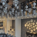 Decoração marcante inspirada em Alice no País das Maravilhas, com xícaras no teto