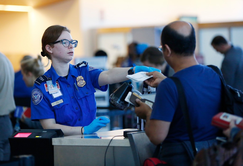 TSA personnel check documents at the security checkpoint in Terminal B at Mineta San Jose International Airport in San Jose, Calif., on Tuesday, April 12, 2016. A nationwide shortage of security personnel and the higher security level following the Belgium terrorist attacks has caused longer than usual boarding times. (Gary Reyes/Bay Area News Group)