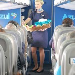 A comissária oferece snacks aos clientes da companhia