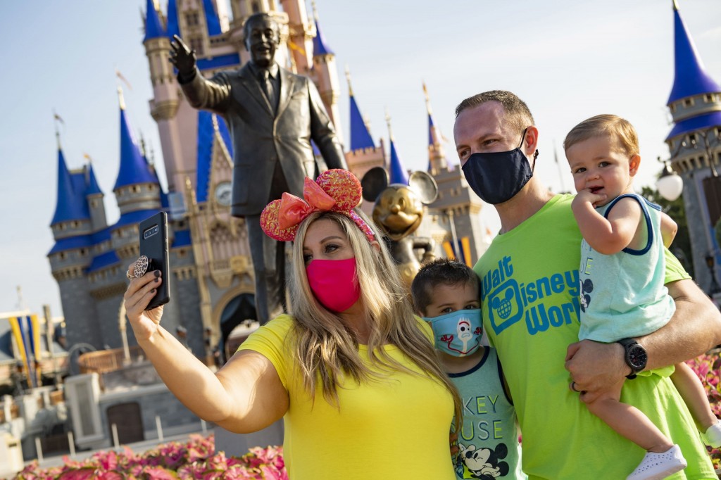 Guests stop to take a selfie at Magic Kingdom Park, July 11, 2020, at Walt Disney World Resort in Lake Buena Vista, Fla., on the first day of the theme park’s phased reopening. (Matt Stroshane, Photographer)