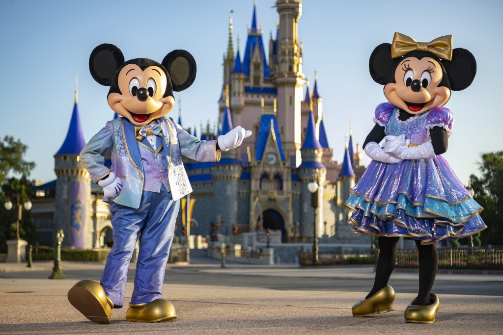 Beginning Oct. 1, 2021, Mickey Mouse and Minnie Mouse will host “The World’s Most Magical Celebration” honoring Walt Disney World Resort’s 50th anniversary in Lake Buena Vista, Fla. They will dress in sparkling new looks custom made for the 18-month event, highlighted by embroidered impressions of Cinderella Castle on multi-toned, EARidescent fabric punctuated with pops of gold. (Matt Stroshane, photographer)