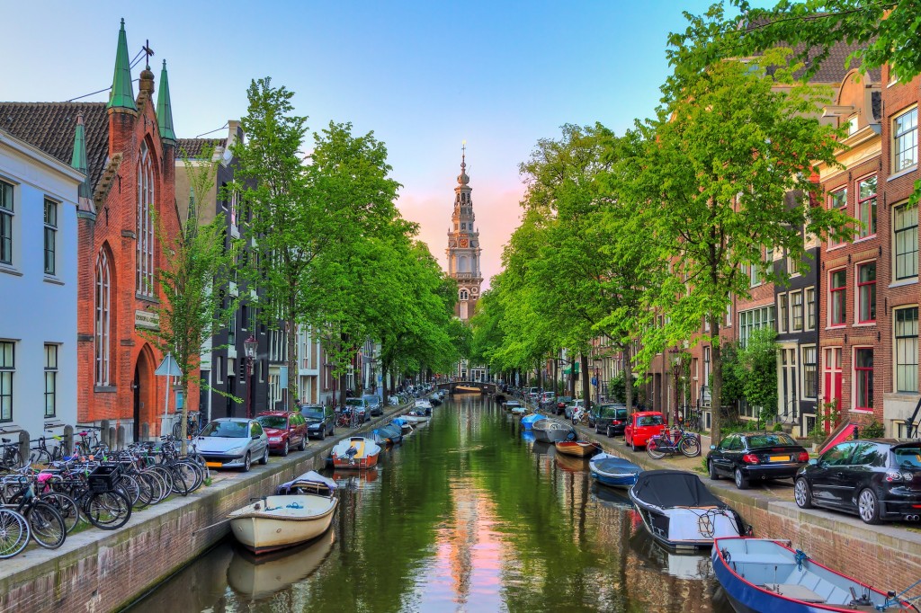 Beautiful Groenburgwal canal in Amsterdam with the Soutern church (Zuiderkerk) at sunset in summer |  These images are protected by copyright. Delta has acquired permission from the copyright owner to use the images for specified purposes and in some cases for a limited time. If you have been authorized by Delta to do so, you may use these images to promote Delta, but only as part of Delta-approved marketing and advertising. Further distribution (including providing these images to third parties), reproduction, display, or other use is strictly prohibited.