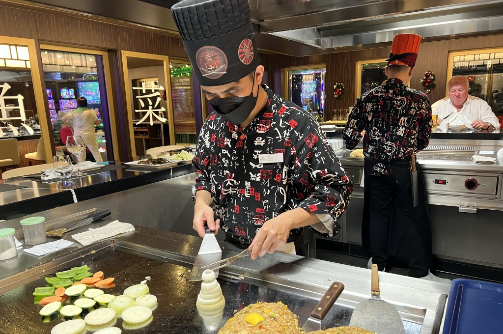 Chef prepara as refeições de frente para os convidados