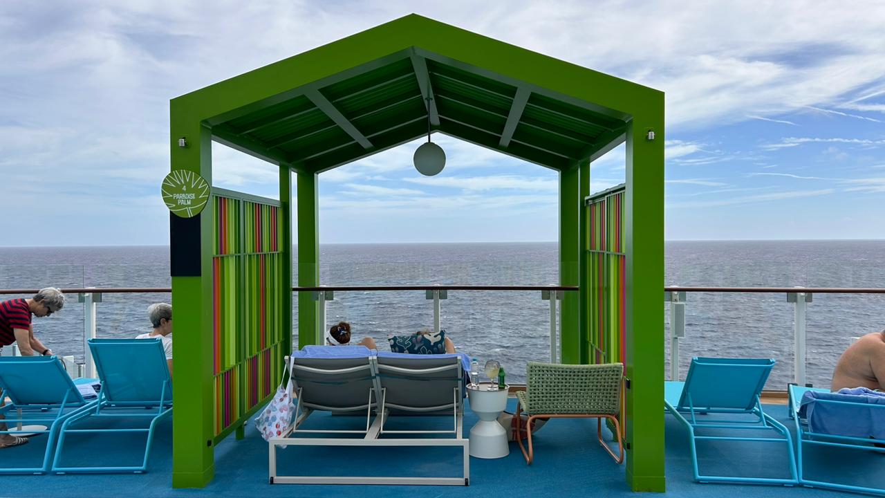 Viajantes curtem vista para o mar nas espreguiçadeiras Viajantes curtem vista para o mar nas espreguiçadeiras
