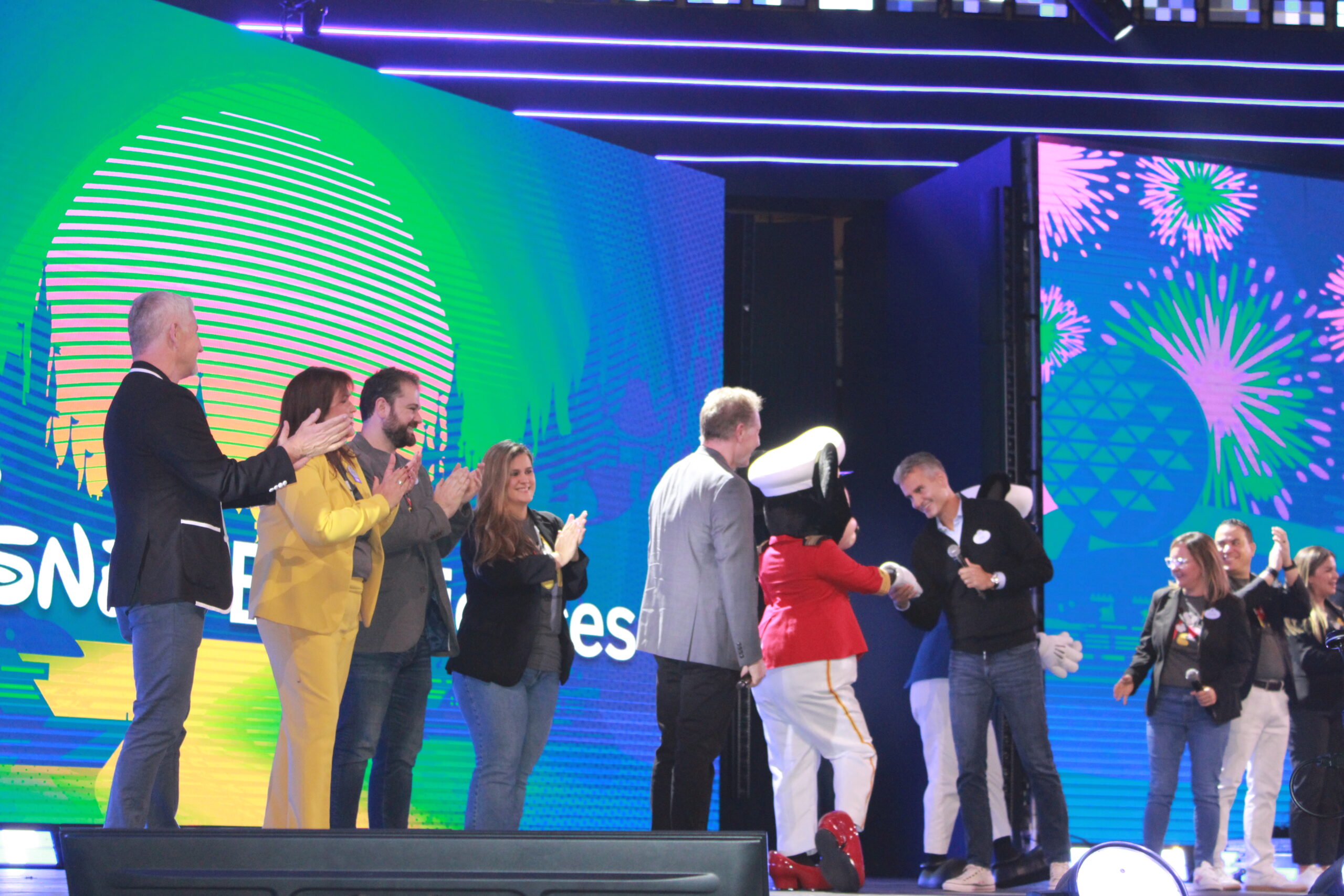 Equipe e representantes do grupo Disney recebem Mickey e Minnie no palco Equipe e representantes do grupo Disney recebem Mickey e Minnie no palco