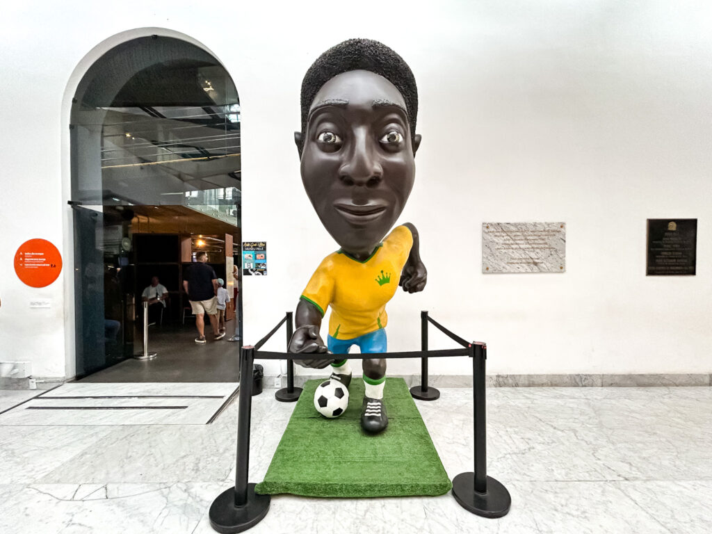 Uma estátua em estilo caricato representa o jogador considerado Rei do futebol