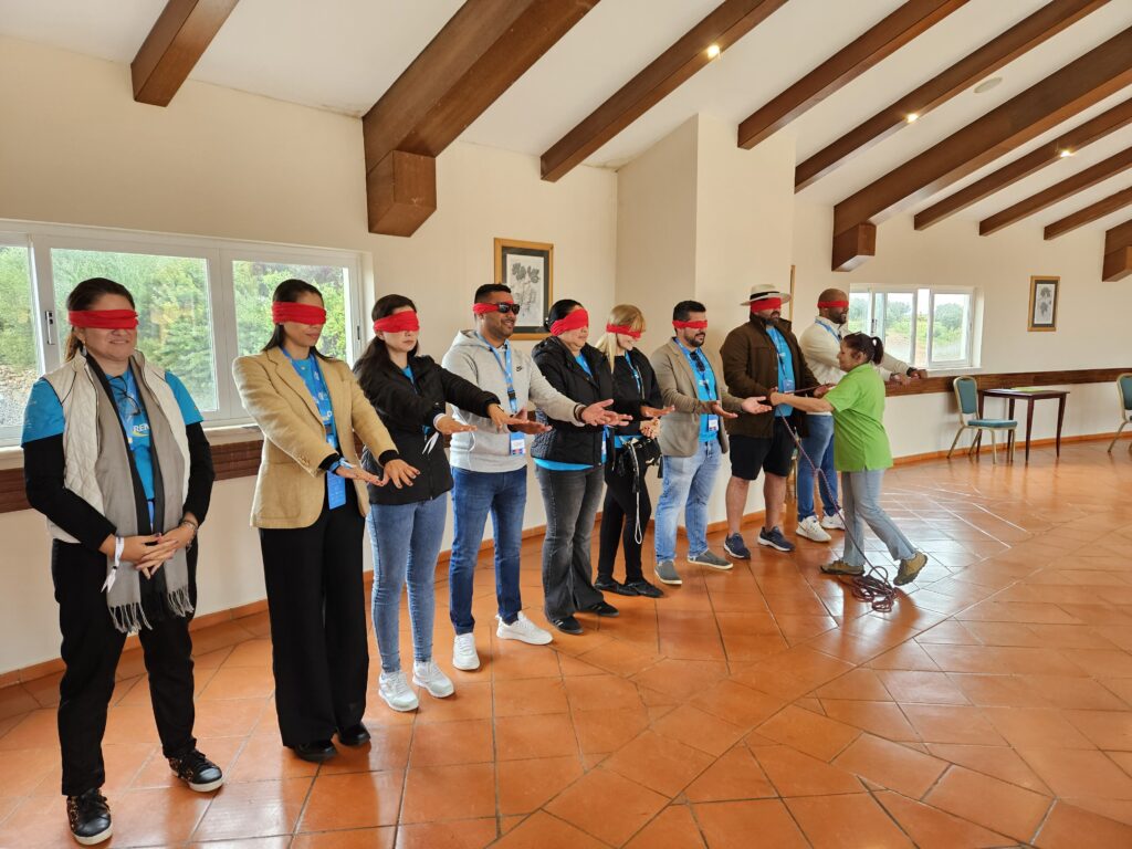 Grupo vermelho na brincadeira da formação de um quadrado perfeito com todos vendados