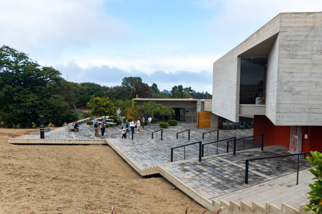 O prédio é feito de concreto pigmentado com tons terrosos, acompanhando as cores naturais do entorno